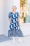 Woman wearing a blue and white abstract patterned maxi dress.