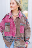 Woman wearing a patchwork jacket with pink and brown colors, standing outdoors.