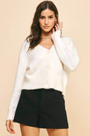 White cardigan sweater with subtle large silver stars woven throughout.