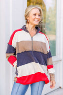 Woman wearing a red, white, and blue striped sweatshirt and jeans.