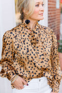 Leopard print satin blouse with bow at neck. 