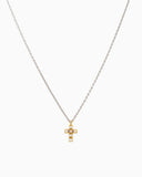 Gold and pearl cross pendant on a silver chain.
