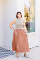 Contrasting monochromatic dress with beige top and gold skirt.