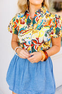 Person wearing a colorful patterned shirt and blue denim bubble skirt with a blurred background