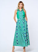 Woman wearing vibrant teal green floral sleeveless halter maxi dress with coordinating belt.
