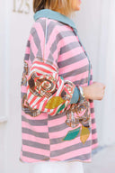 Person wearing a pink and gray striped shirt with a boho floral design.