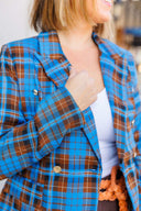 Woman wearing a blue plaid blazer outside Laundry Dae Boutique.