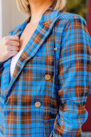 Woman wearing a blue plaid blazer outside Laundry Dae Boutique.