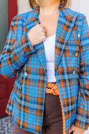 Woman wearing a blue plaid blazer outside Laundry Dae Boutique.