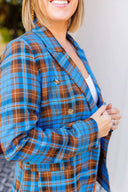 Woman wearing a blue plaid blazer outside Laundry Dae Boutique.