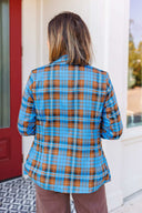 Woman wearing a blue plaid blazer outside Laundry Dae Boutique.