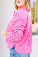 Person wearing a bright pink top with blurred background
