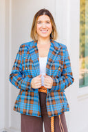 Woman wearing a blue plaid blazer outside Laundry Dae Boutique.
