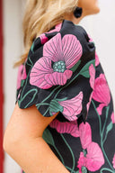 Close-up of a black top with pink floral patterns