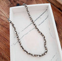 Necklace with small rhinestones on a marble surface