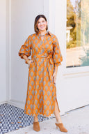 Floral orange maxi dress with side slits and matching sash.