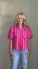 Video of woman modeling pink and red striped top.