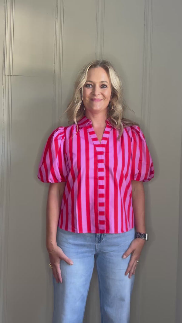 Video of woman modeling pink and red striped top.