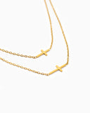 Double layer gold cross necklace.