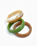 Three marble bangles in brown, green, and ivory.